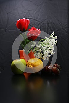 Fresh wet fruits : lemon, green apple and grapes with decoration on black background