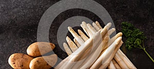 Fresh white asparagus on black background