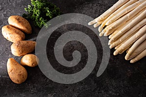 Fresh white asparagus on black background