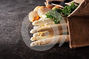 Fresh white asparagus on black background