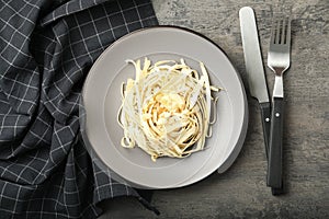 Fresh white carrot salad served on grey table, flat lay