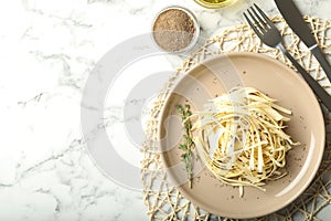 Fresh white carrot salad served on marble table, flat lay. Space for text