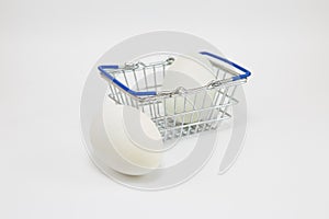 Fresh white eggs in a shopping basket