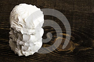 Fresh white marshmallows in a pile lay on brown wooden table