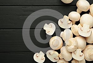 Fresh white mushrooms champignon on black background