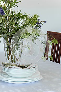 Fresh white tableware set: napkins,plates, silver utensils