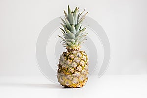 Fresh whole pineapple on a white background