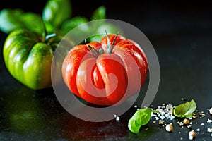 Fresh ripe red tomato with water droplets