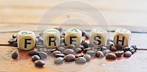Fresh on wooden block with group of coffee beans on table. fresh and enery beverage concept