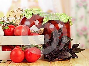 Fresh in wooden box and cans canned tomatoes, spices isolated.