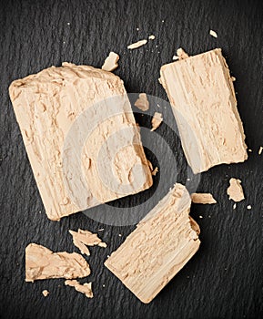 Fresh yeast on the gray table closeup. Ingredient for baking bread and bakery products