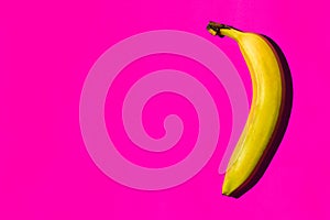 Fresh yellow bananas on pink background with copy space for your text, top view.