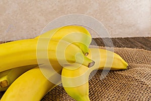 Fresh yellow bananas,wood,table,burlap cloth