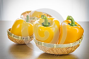 Fresh yellow bell peppers in basket