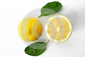 Fresh yellow lemon with green leaf on white background