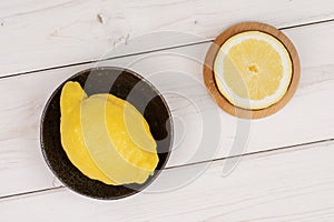 Fresh yellow lemon on grey wood