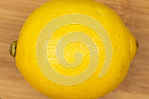 Fresh yellow lemon on light wood
