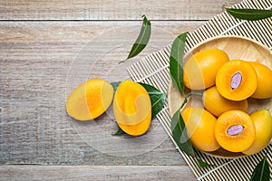 Fresh yellow marian plum fruit (Mayongchid in Thai name) on wood