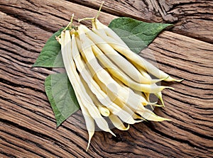 Fresh yellow string beans on the old wood.