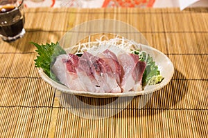Fresh yellowtail sashimi - hamachi sashimi on bamboo mat