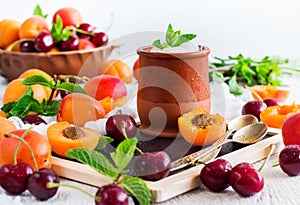 Fresh yogurt with organic ripe apricots and cherries
