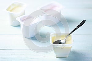 Fresh youghurt in plastic pack on table closeup.Colorful yogurts