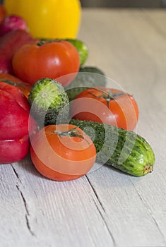 Fresh young vegetables on a wooden kitchen table