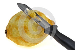 Fresh zested lemon with kitchen utensil