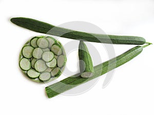 Fresh zucchini, sliced in a bowl and Green vegetables is arrange