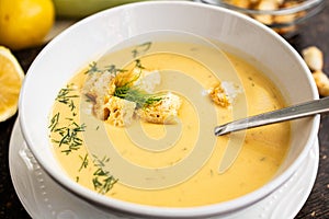Fresh zucchini soup with croutons and dill