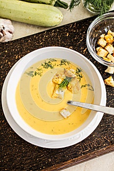 Fresh zucchini soup with croutons and dill