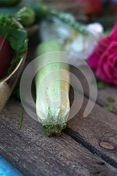 Fresh zucchini on a wooden old background with vegetables.