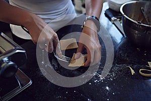 The fresher the better. an unrecognizable young woman cooking homemade pasta at home.