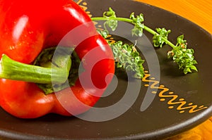 a freshest red paprika, bell pepper in ceramic plate