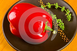 a freshest red paprika, bell pepper in ceramic plate