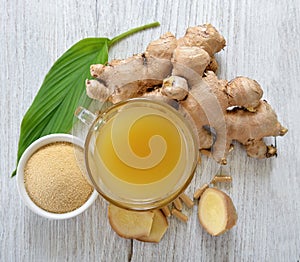 Freshginger,ginger juice and capsules on wooden