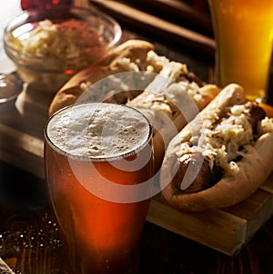Freshlly poured IPA beer in mug served with bratwursts