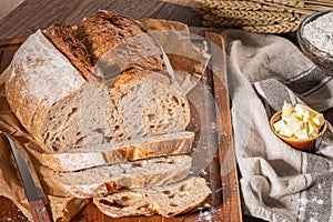 Freshly artisan baked wheat and rye bread, country bread. Simple bread  with butter for breackfast photo