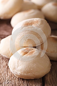 Freshly baked Arabic bread batbout macro. Vertical
