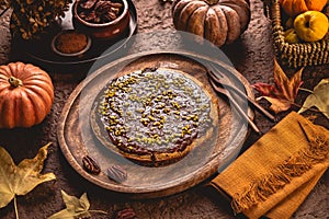 Freshly baked autumn pumpkin cake with nuts and ganache