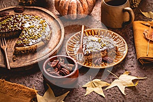 Freshly baked autumn pumpkin cake with nuts and ganache