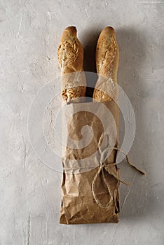 Freshly baked baguette on bright background, top view