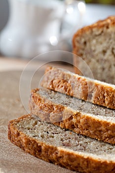 Freshly baked banana bread sliced on wooden board