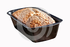 Freshly baked banana bread in tin loaf pan