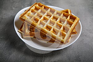 Freshly baked belgium waffles in plate