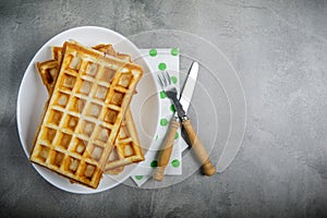 Freshly baked belgium waffles in plate with copy space. From top