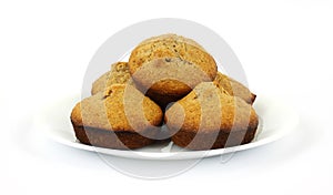 Freshly baked bran muffins on white plate