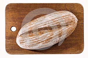 Freshly baked bread, on the kitchen board isolated on white. Top view