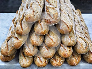 Freshly baked bread loaves stacked typical french baguette