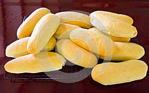 Freshly baked bread rolls cooling on a metal rack